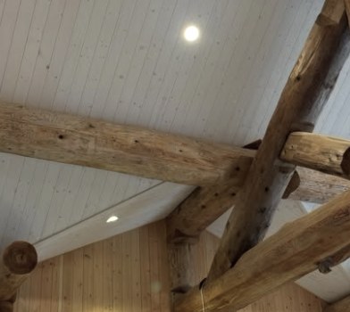 Exposed timber beams under a lined ceiling